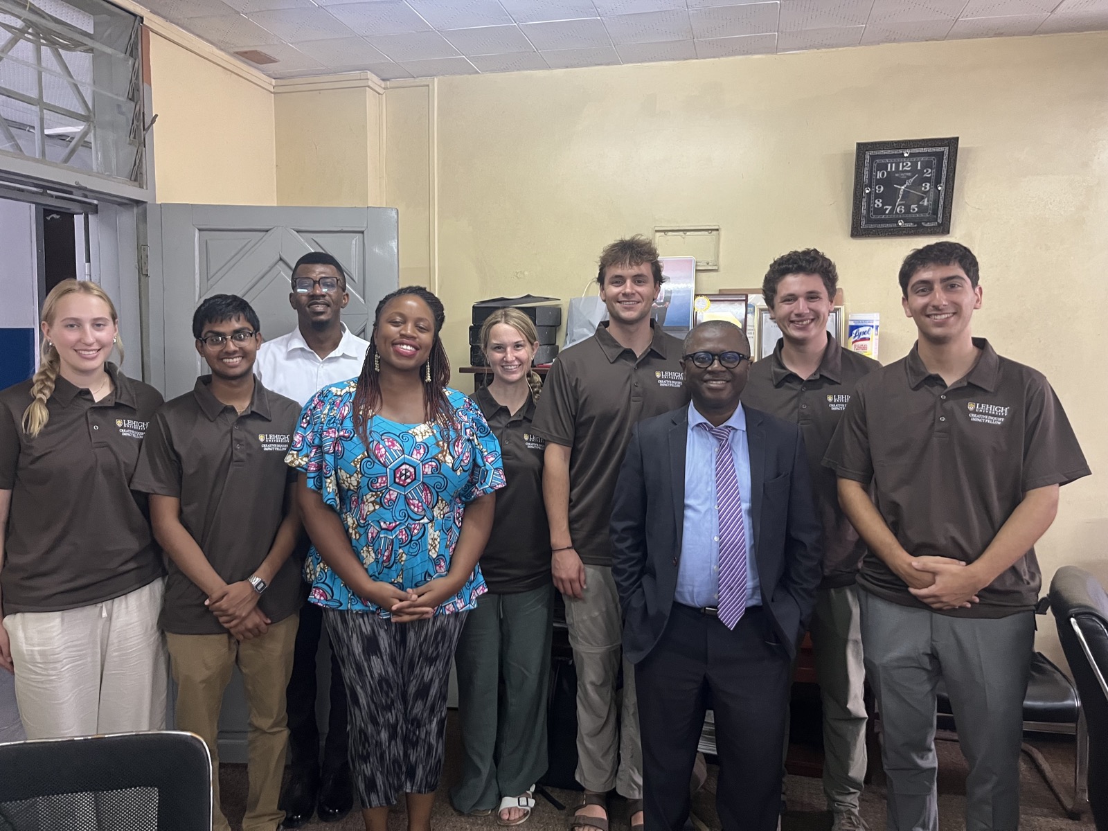 The AISHA team standing with officials from the Ministry of Health and Sanitation